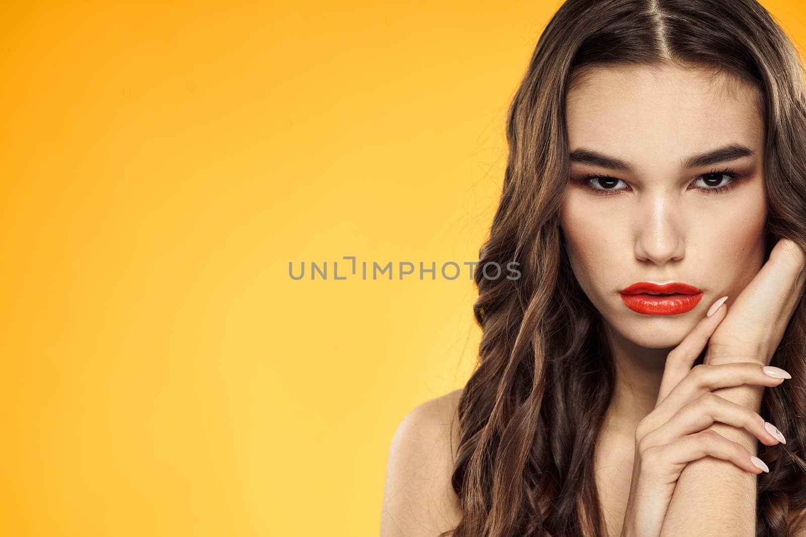Woman with bare shoulders red cropped lips charm yellow background. High quality photo