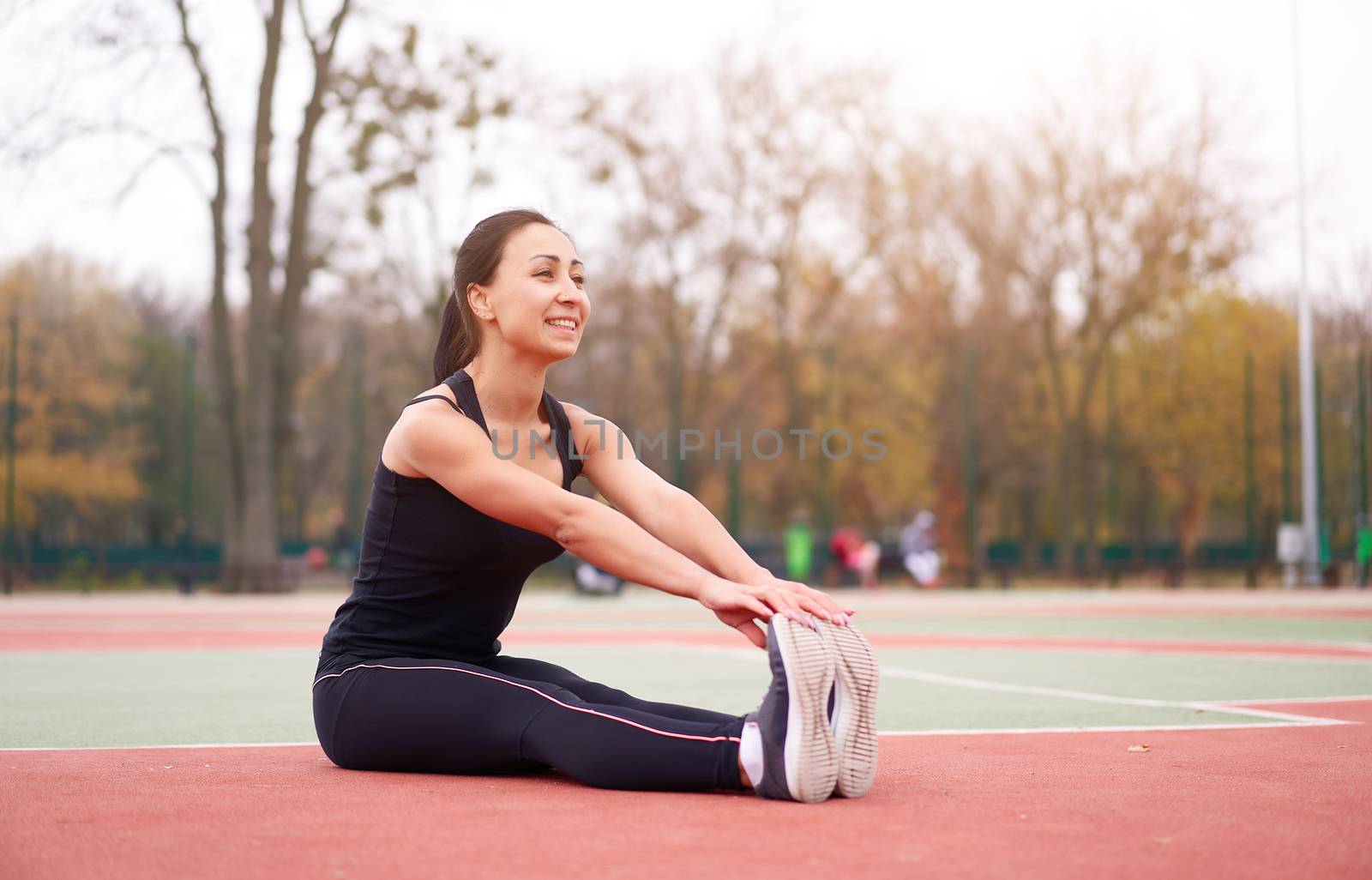 Happy girl doing fitness exercises outdoor on playground. Healthy lifestyle. Morning workout positive emotion smiling sportive people by andreonegin