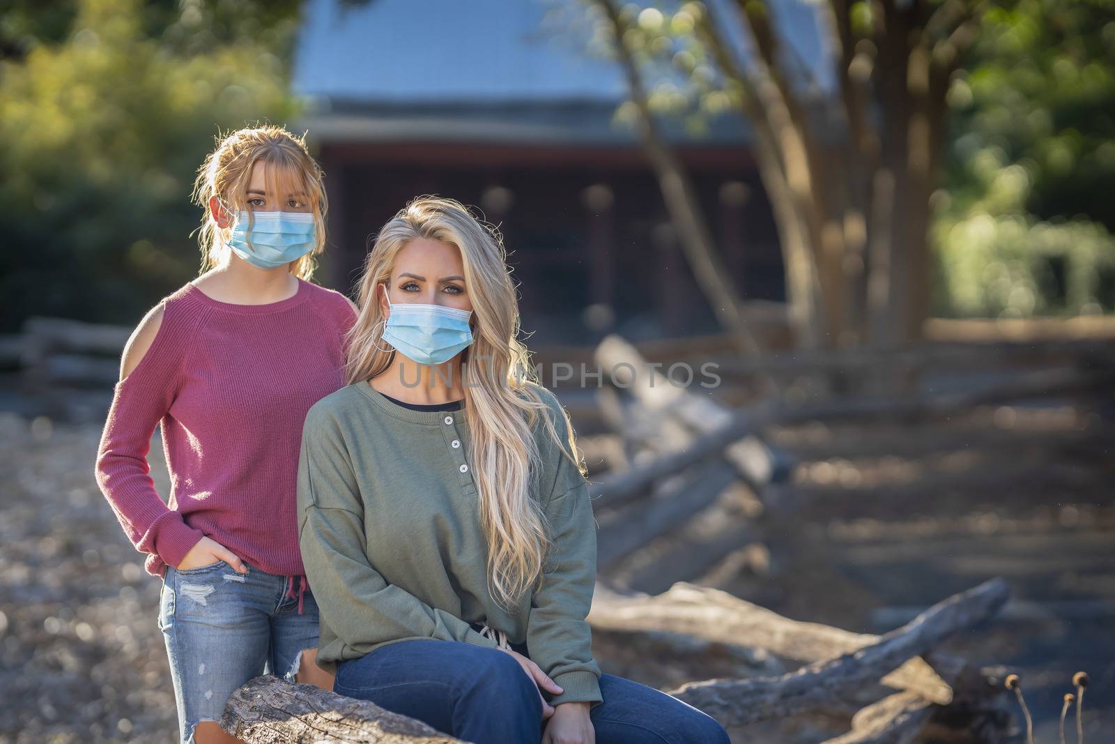 A mother and daughter enjoy a day outdoors while wearing masks and maintaining a safe distance from others during the Covid-19 pandemic