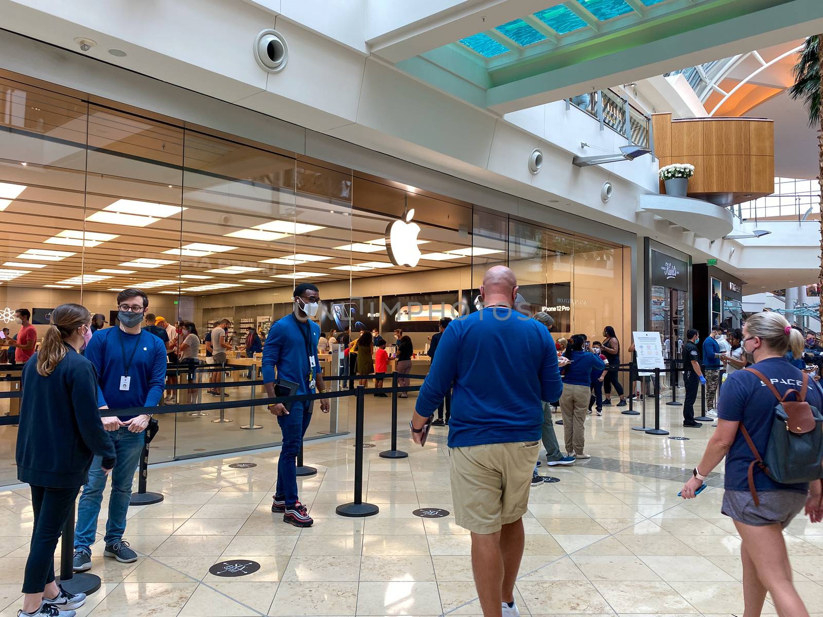 People waiting in line at the Apple retail store to look at and by Jshanebutt