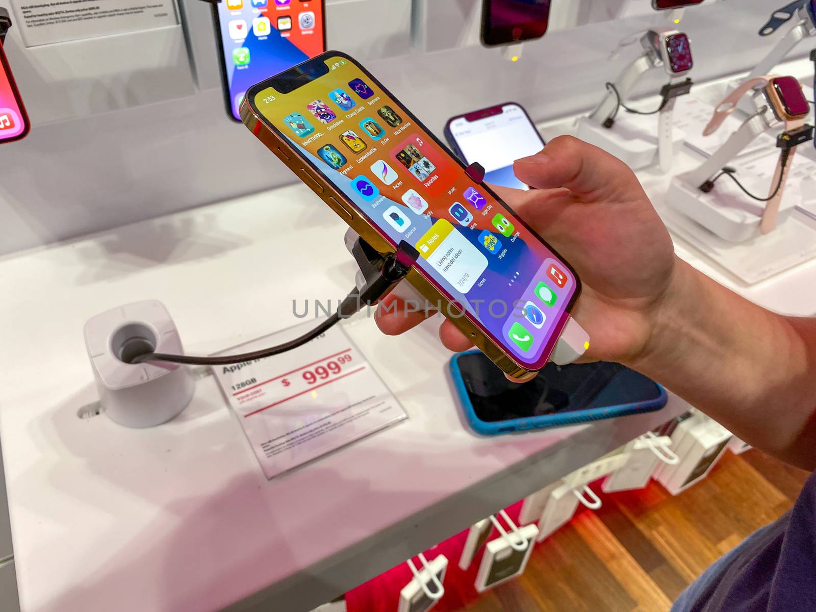 Orlando, FL/USA - 10/25/20: A person trying out the new Apple iPhone 12 and 12 Pro on display at the T Mobile store.