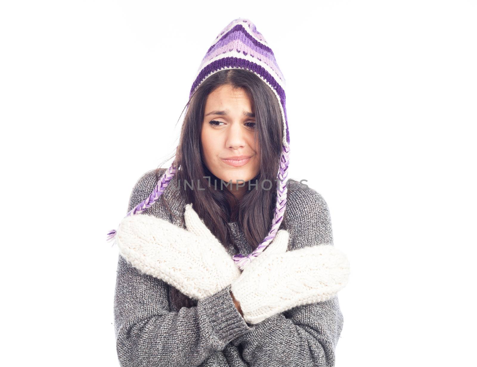 pretty brunette woman with a woolen Peruvian hat a sweater and gloves that has cold