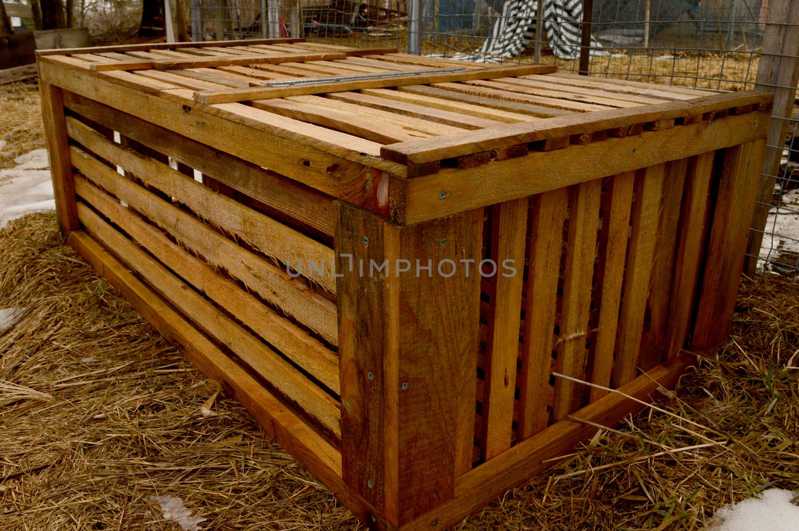 An empty livestock crate used for shipping animals to the farm.