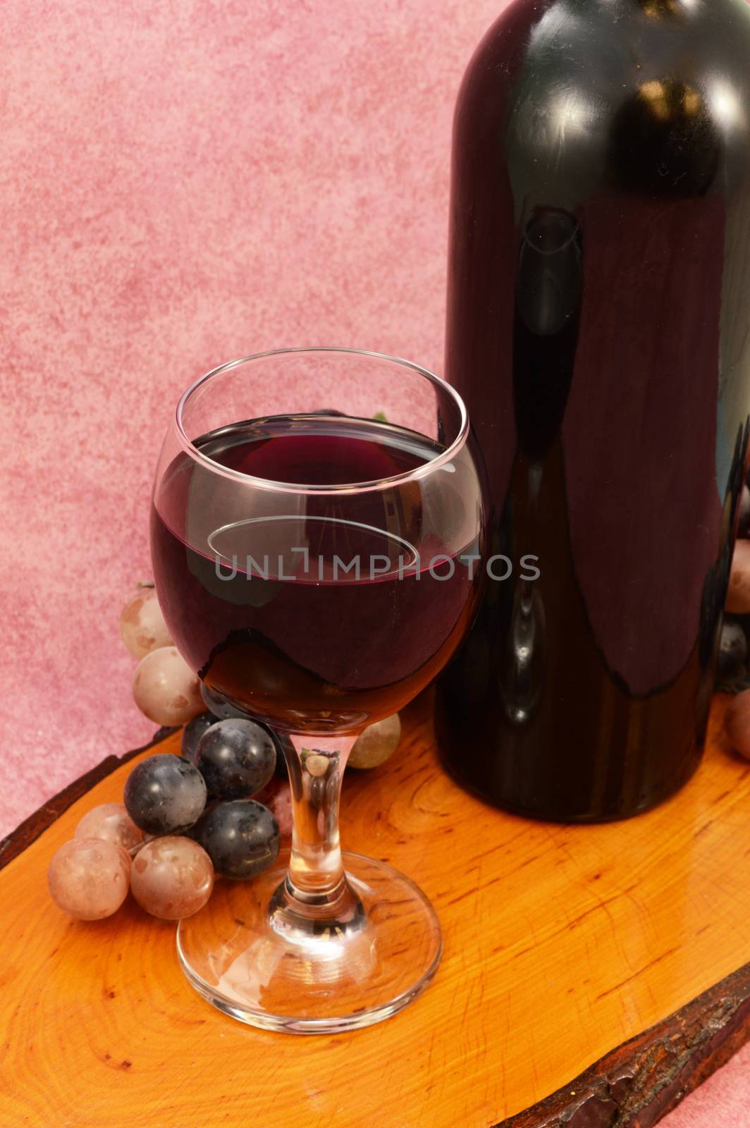 A glass of fresh grape wine from a newly opened bottle.