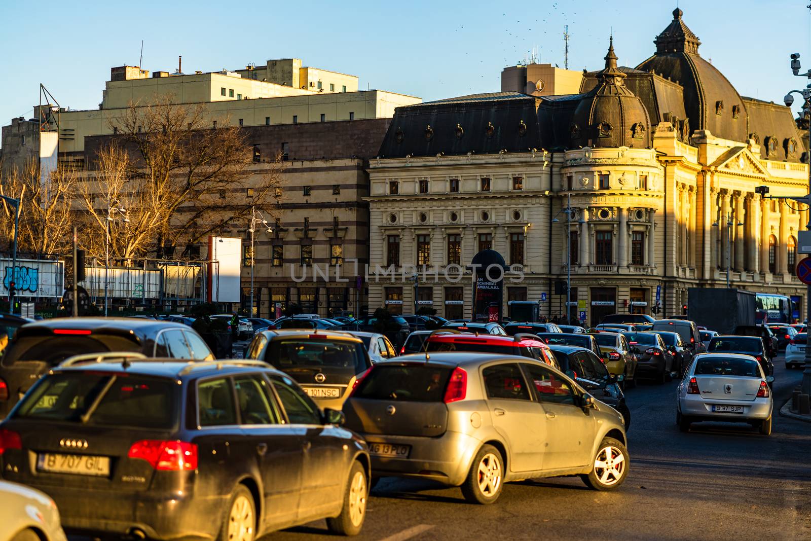 Car traffic at rush hour in downtown area of the city. Car pollu by vladispas