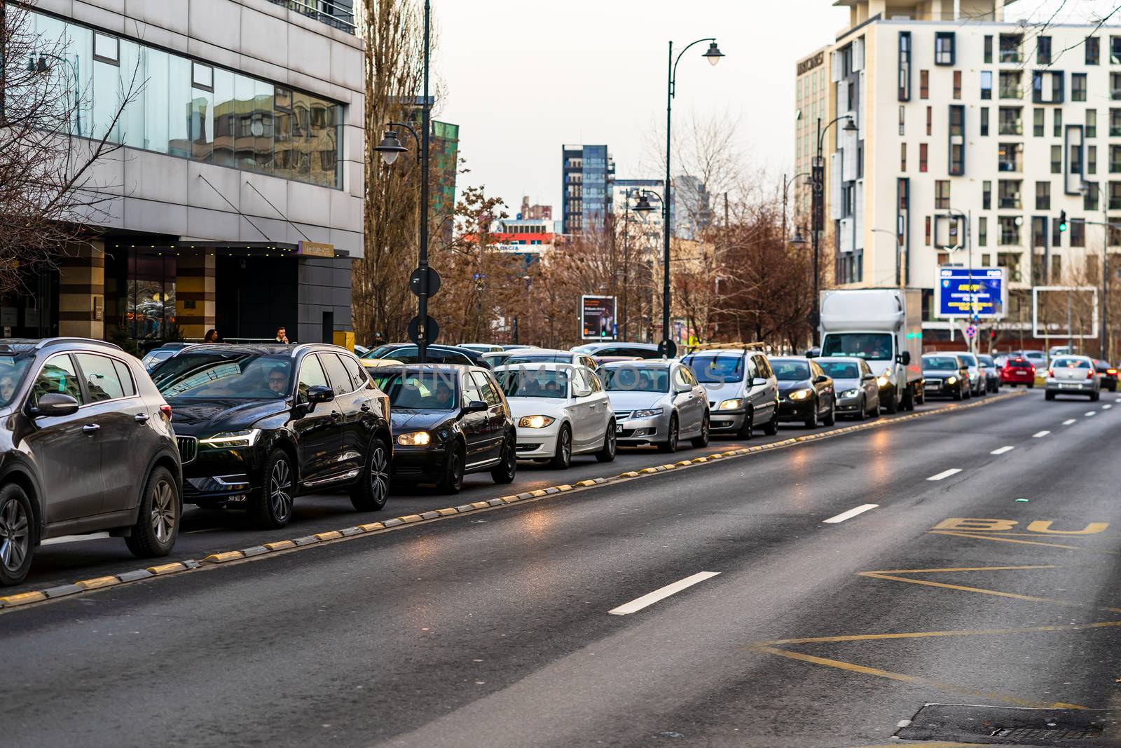 Car traffic at rush hour in downtown area of the city. Car pollu by vladispas