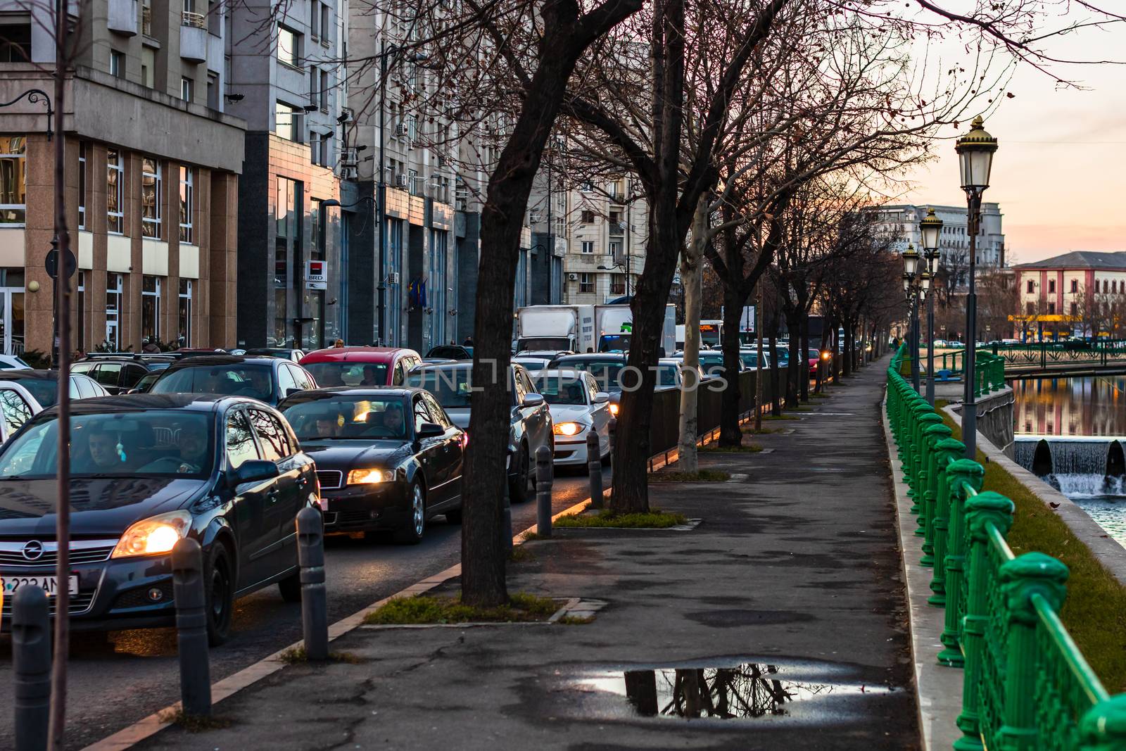 Car traffic at rush hour in downtown area of the city. Car pollu by vladispas