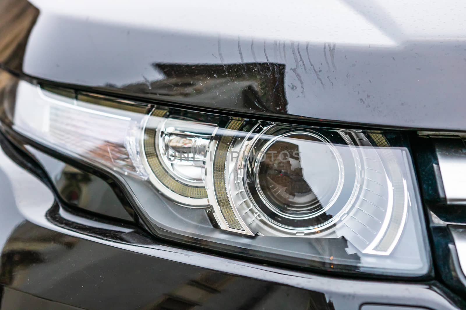 Close up photo of modern car, detail of headlight. Headlight car by vladispas