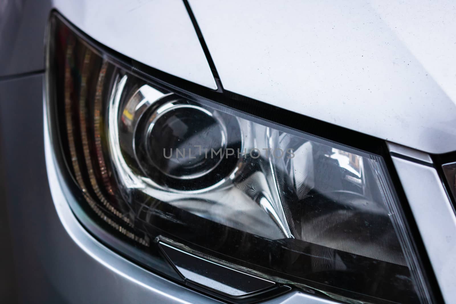 Close up photo of modern car, detail of headlight. Headlight car Projector LED of a modern luxury technology and auto detail.