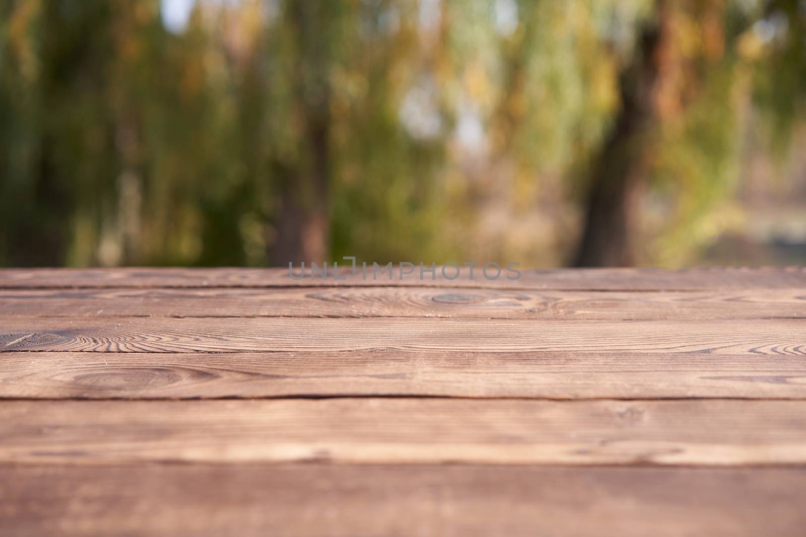 Empty wooden table nature bokeh background with a country outdoor theme,Template mock up for display of product by andreonegin