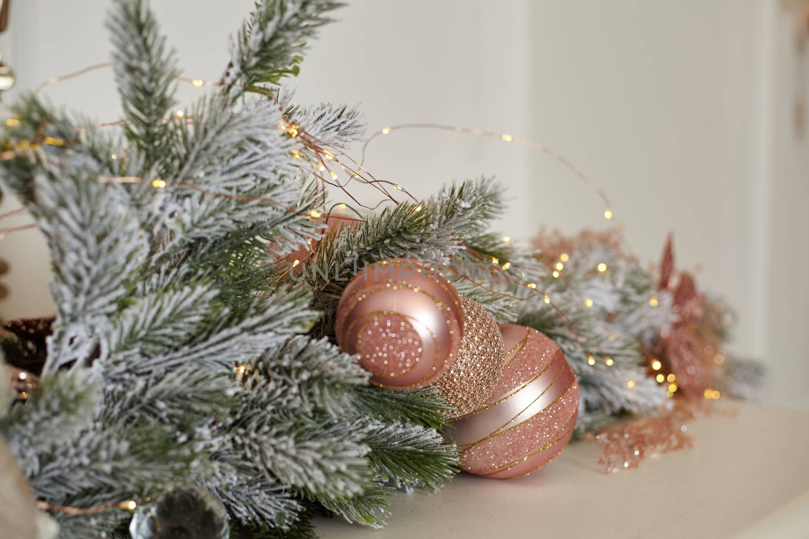 Christmas tree blur garland close-up New year background Decoration with snow and branch of Christmas tree