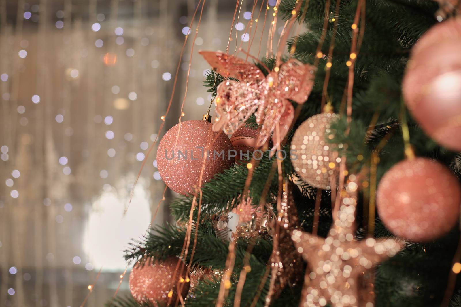 Christmas tree blur garland close-up New year background Decoration with snow and branch of Christmas tree