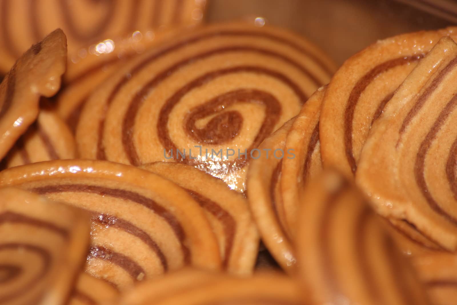 Closeup view with selective focus of a large number of round cookies by Photochowk