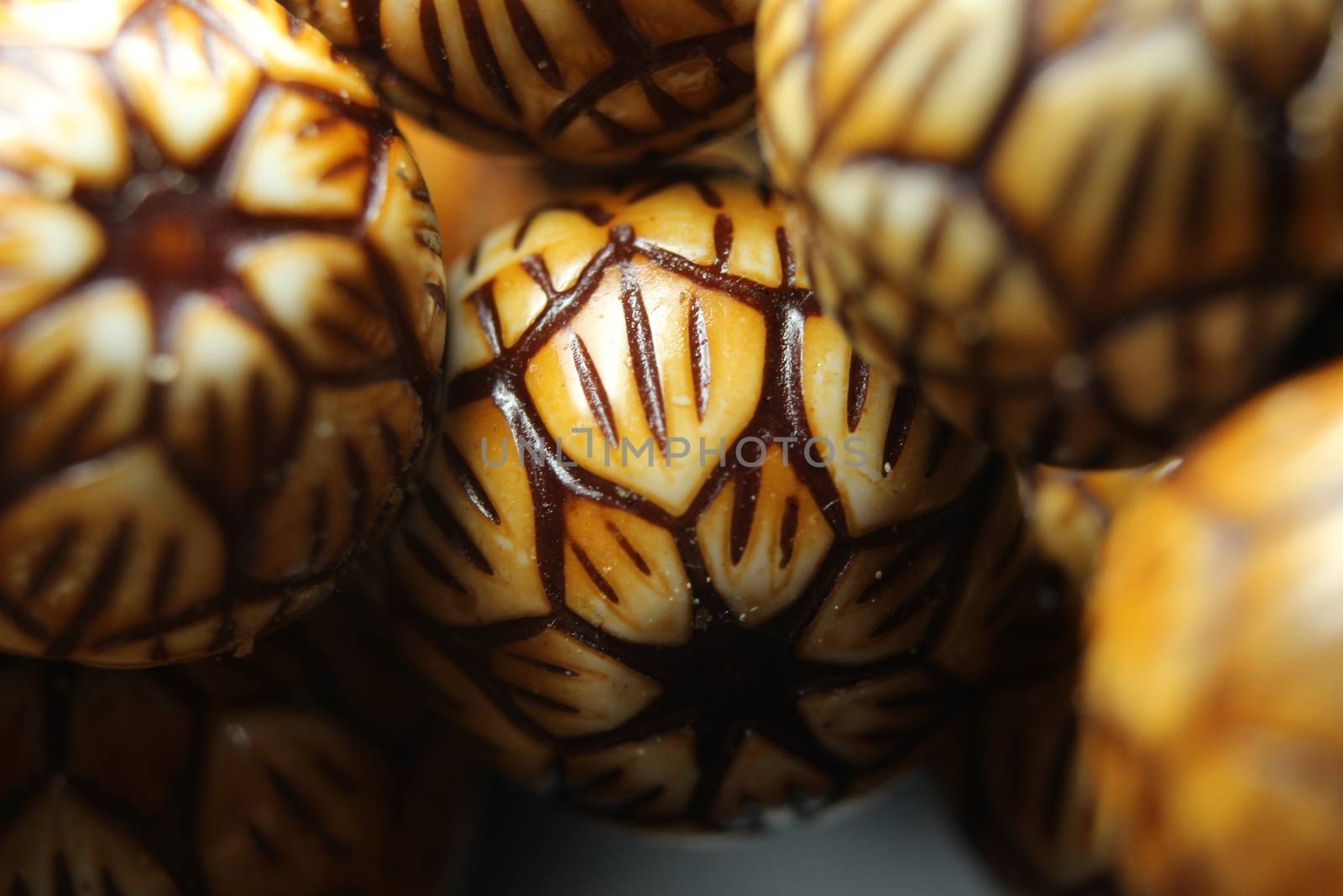 Beautiful wooden prayer beads or rosary with a striped background by Photochowk