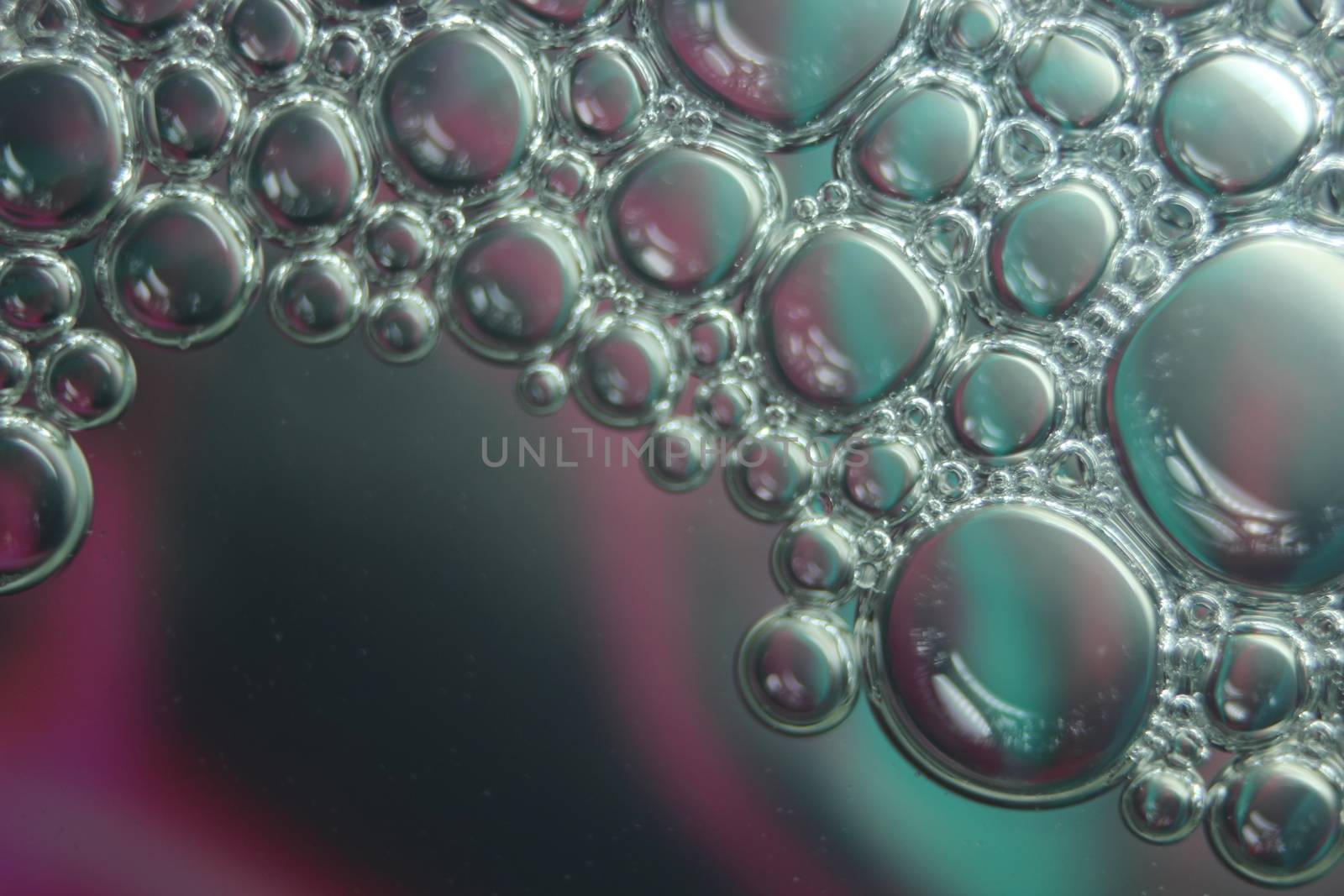 abstract macro background of oil circles floating over water surface . by Photochowk