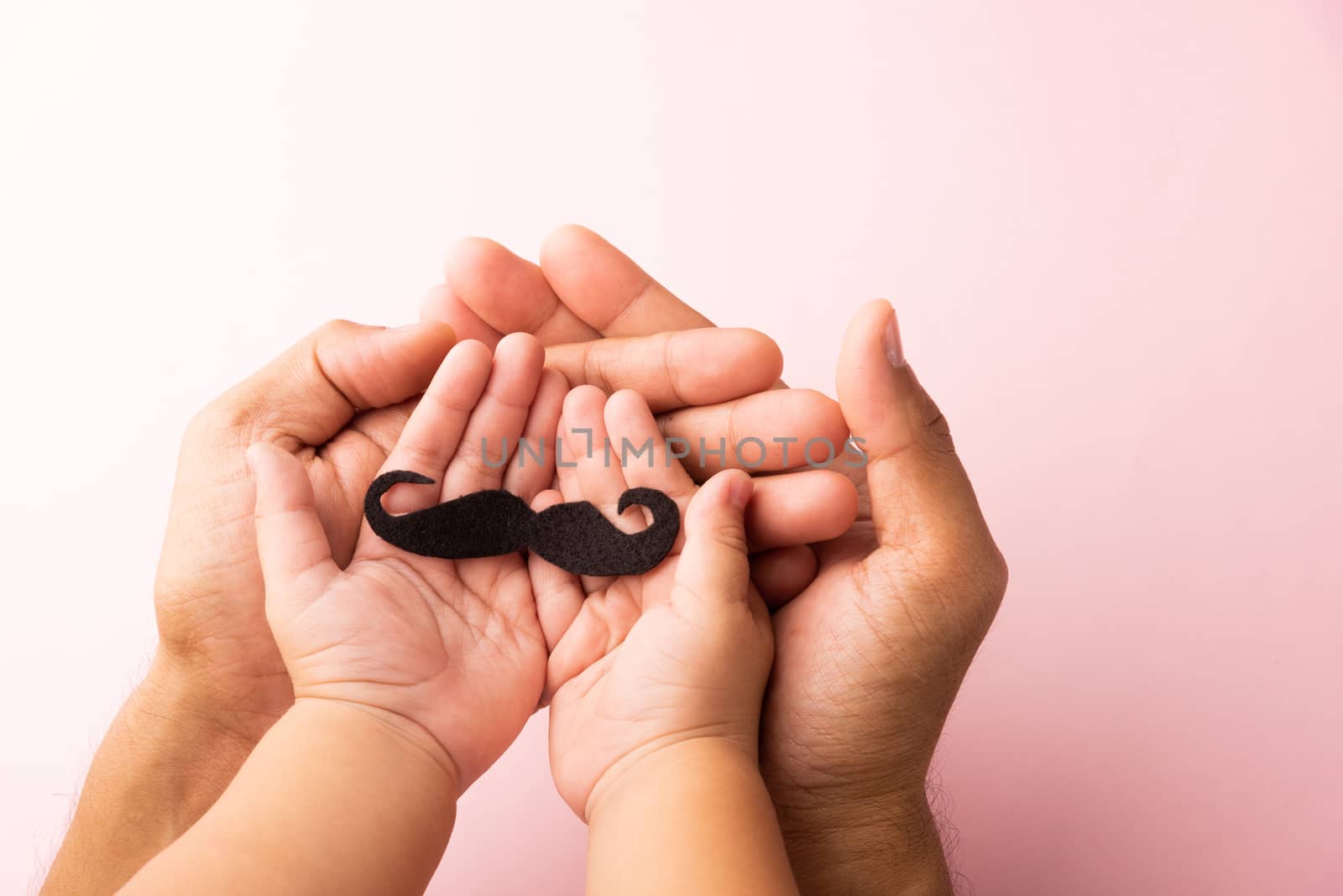 Father and his son kid uses hand holding black mustache, studio shot isolated on white background, Prostate cancer awareness month, Fathers day, minimal November moustache concept