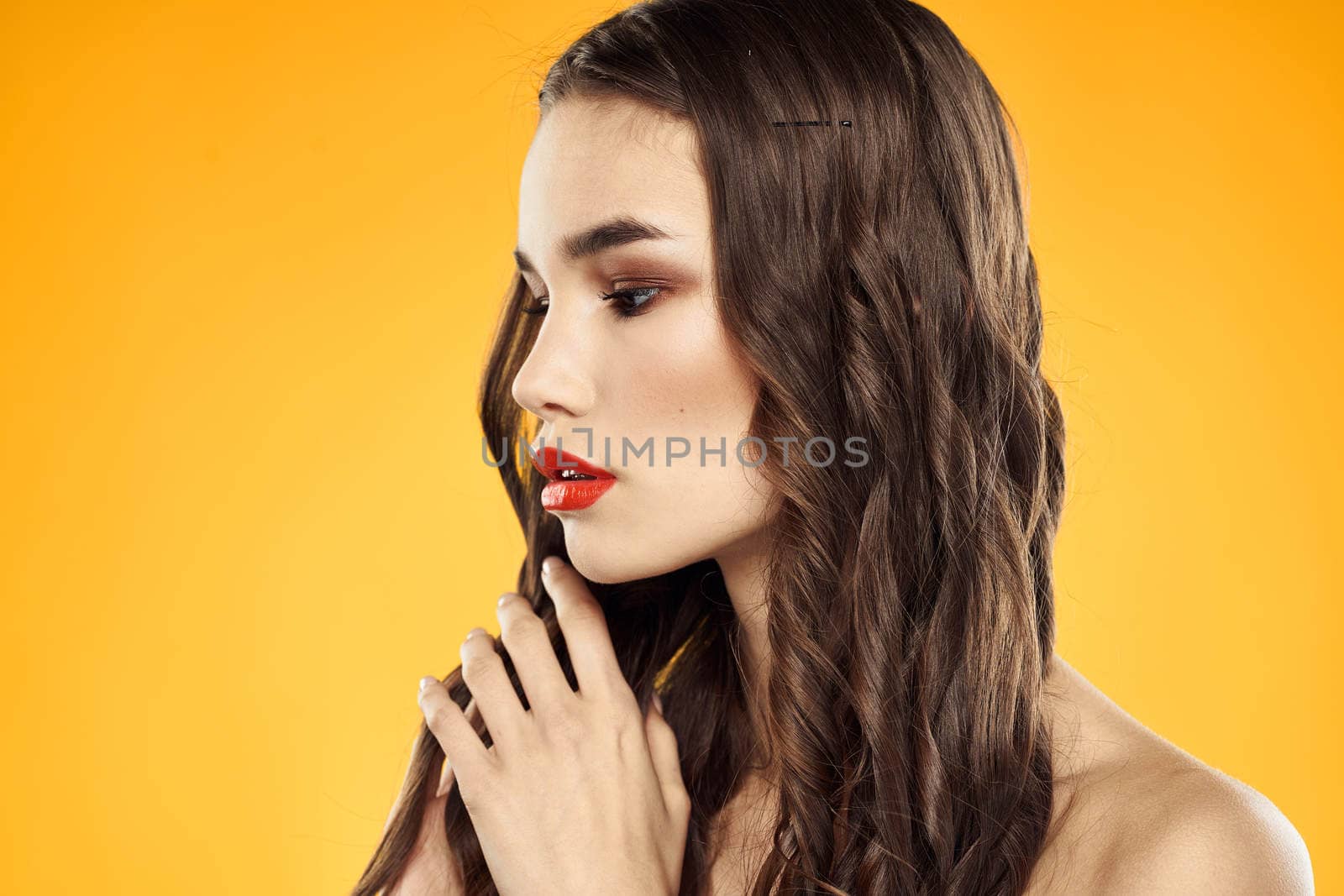 Woman with bare shoulders red cropped lips charm yellow background. High quality photo