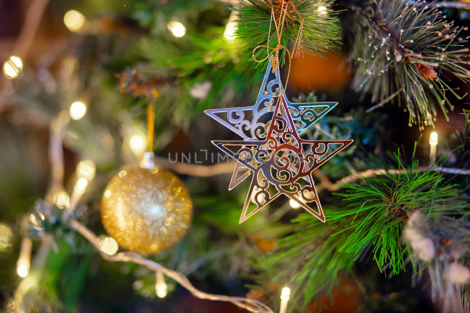 gold star hanging on the branch of the Christmas tree. Christmas tree decoration. Preparation for the holiday
