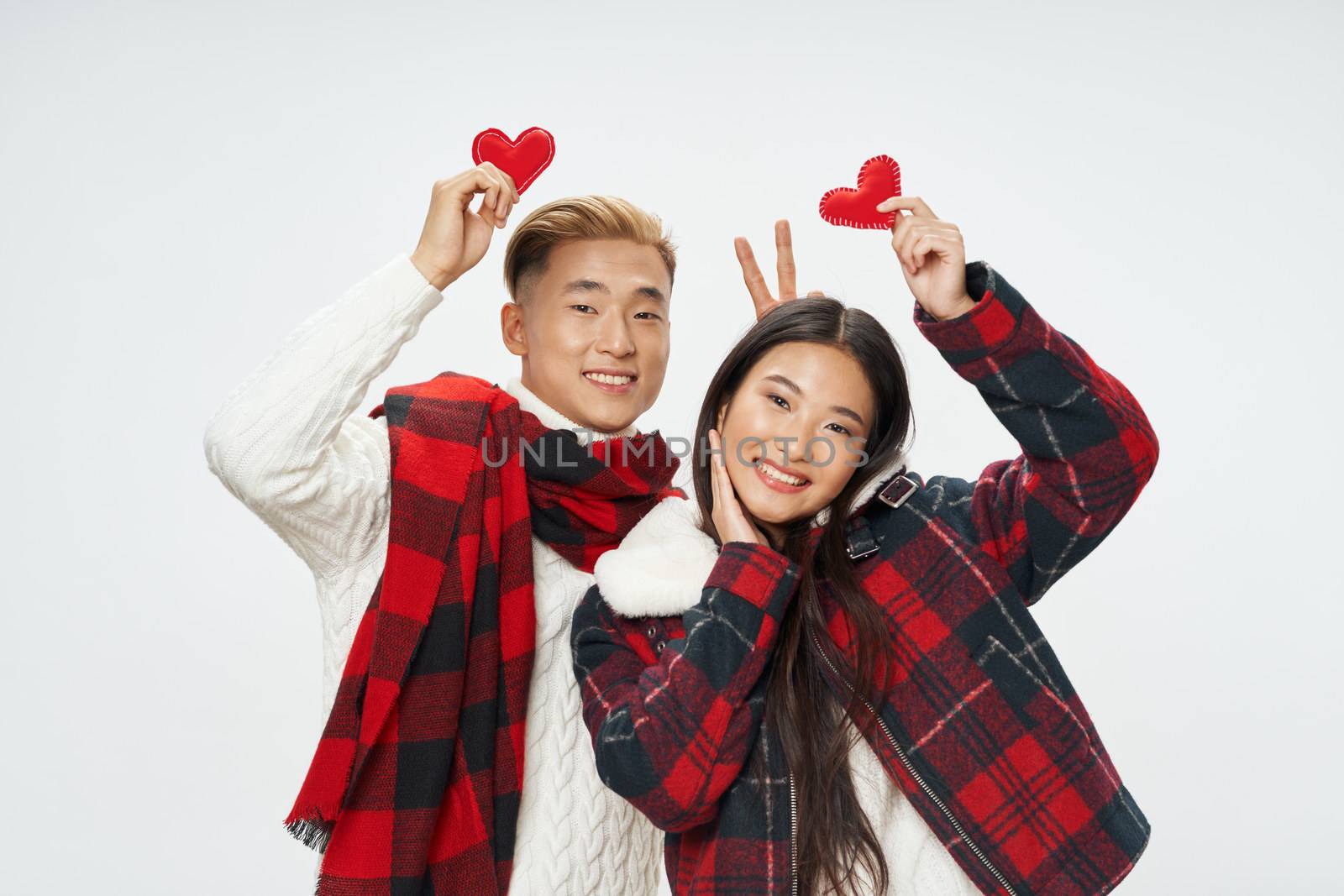 Woman man and woman of Asian appearance smile heart in hands winter holiday fun
