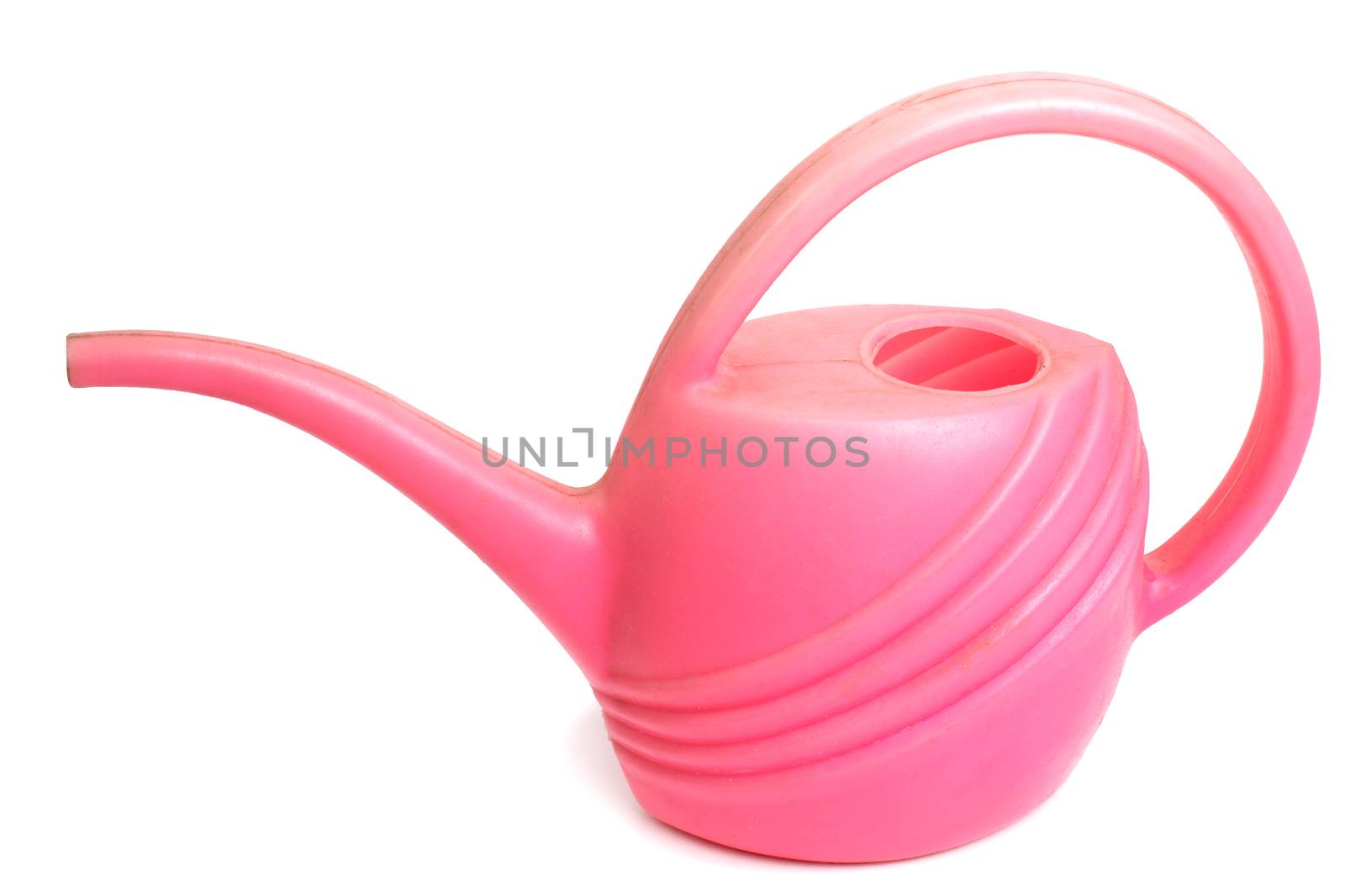 Old dirty pink plastic watering can, isolated standing on a white background