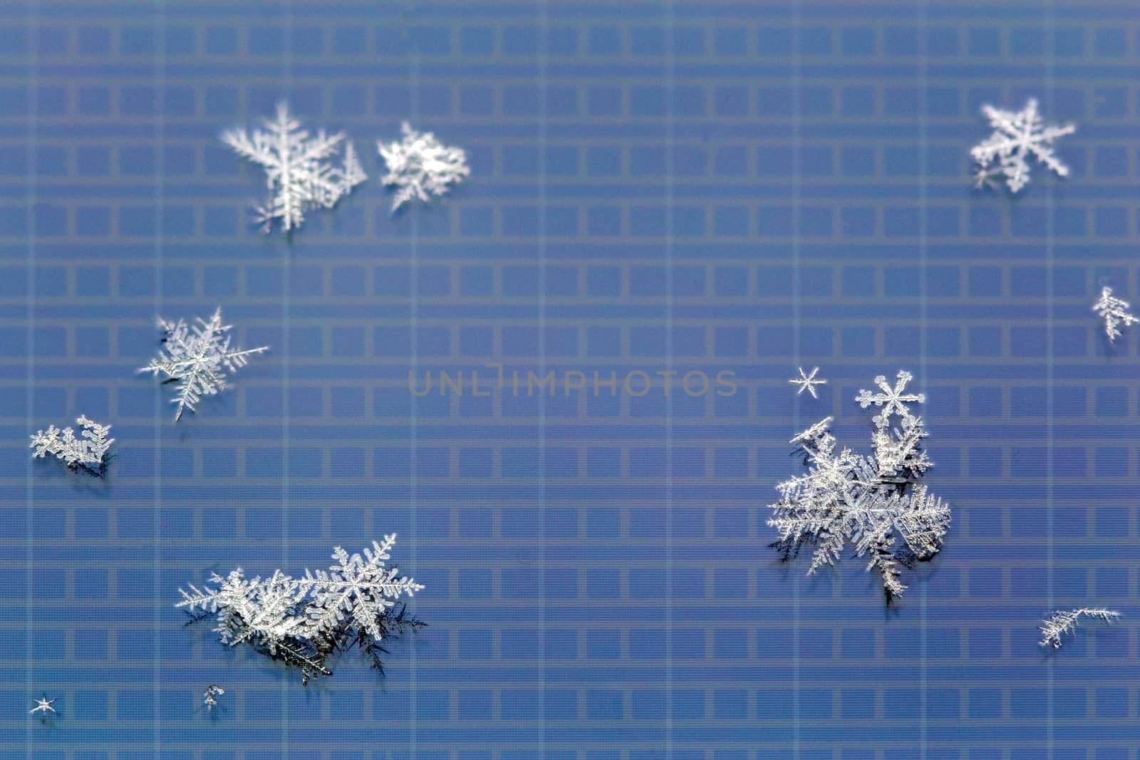 snowflakes on LCD screen of mobile phone macro background.