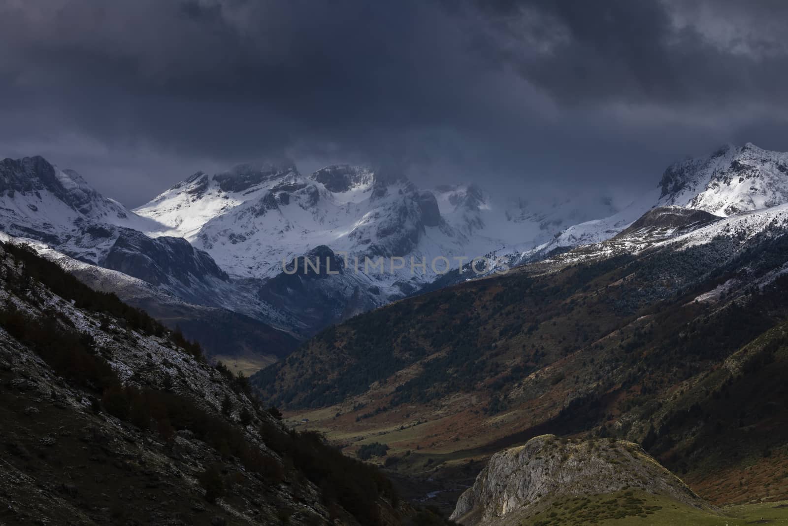 Snowy mountains landscape in the Aragonese Pyrenees. Cloudy view of the Guarrinza pastures, near of Aguas Tuertas valley, Hecho and Anso, Huesca, Spain.