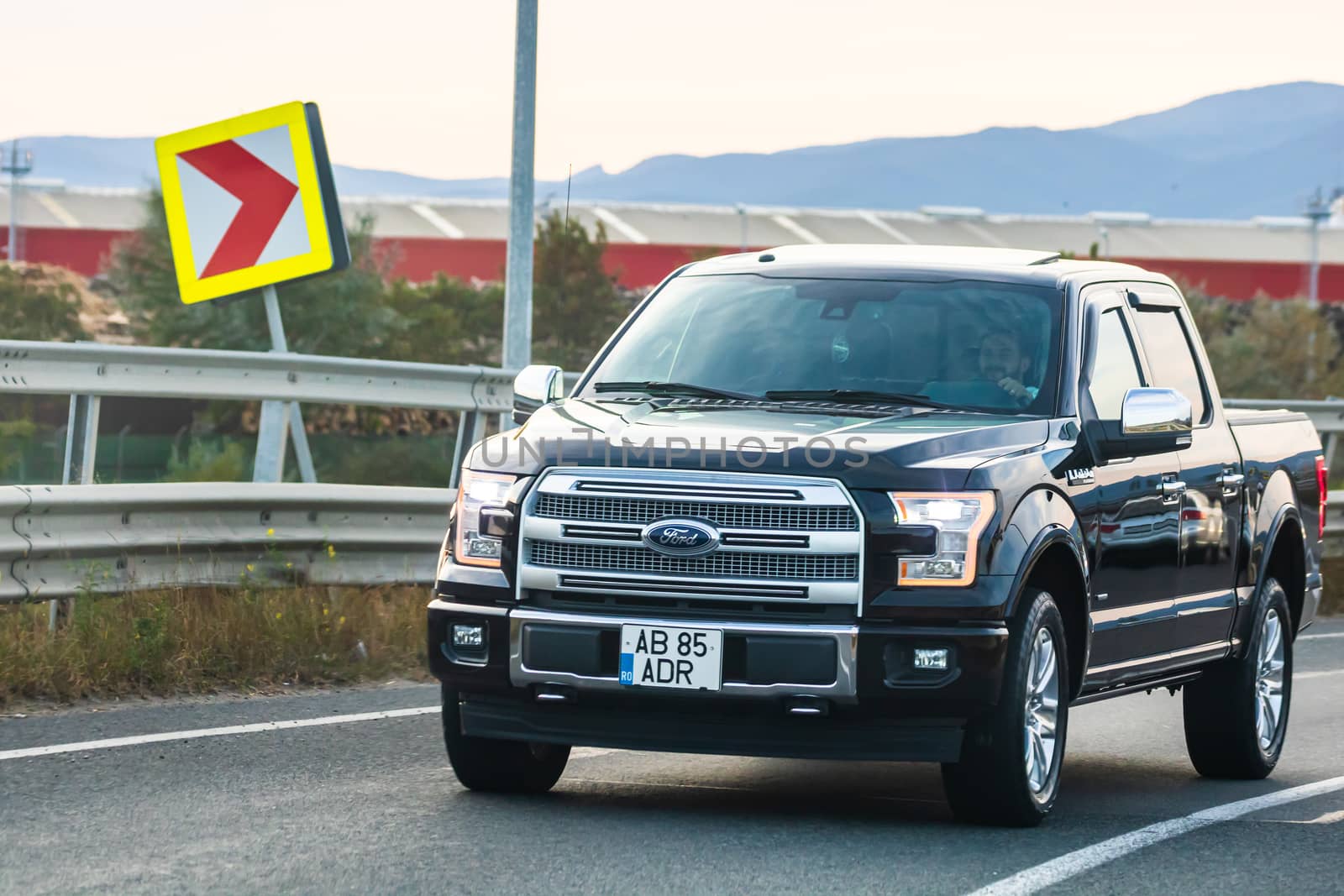 Traveling  Ford Pickup car in motion on asphalt road, front view of car on street. Bucharest, Romania, 2020