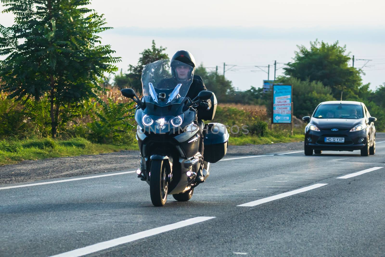 Traveling motorcycle in motion on asphalt road, front view of mo by vladispas