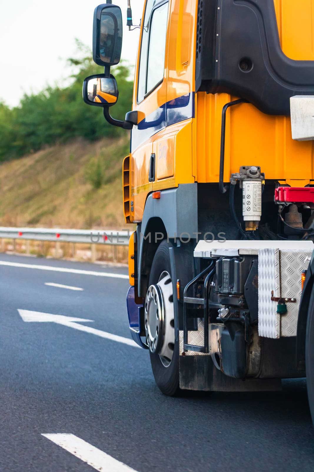 Side view of loaded European truck in motion on asphalt road, transportation and delivery concept. Detail on delivery truck. Bucharest, Romania, 2020