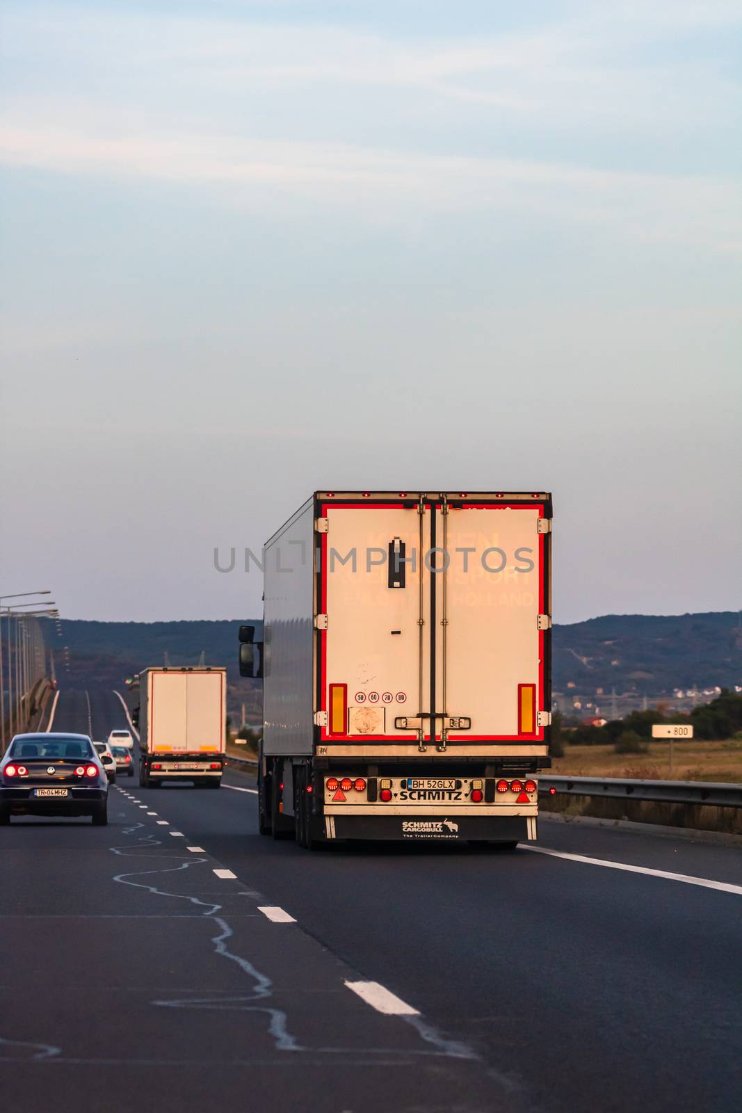 Back view of loaded European truck in motion on asphalt road, transportation and delivery concept. Bucharest, Romania, 2020