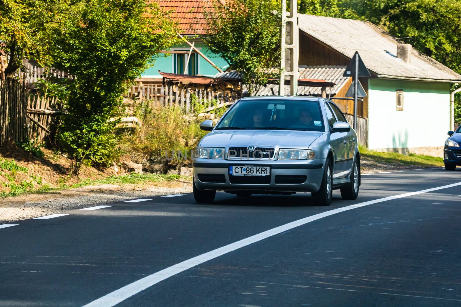 Traveling car in motion on asphalt road, front view of car on street. Bucharest, Romania, 2020