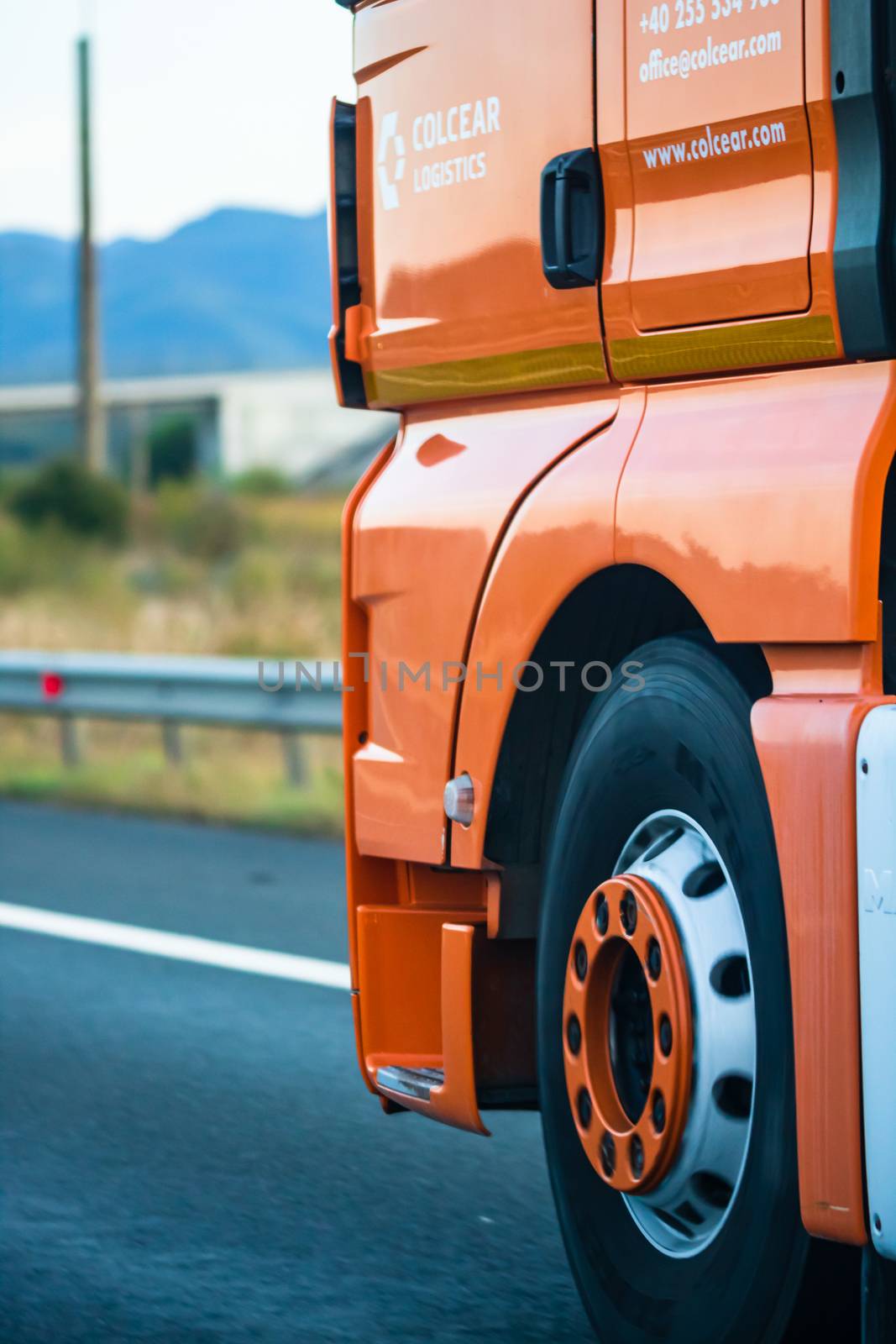 Side view of loaded European truck in motion on asphalt road, transportation and delivery concept. Detail on delivery truck. Bucharest, Romania, 2020