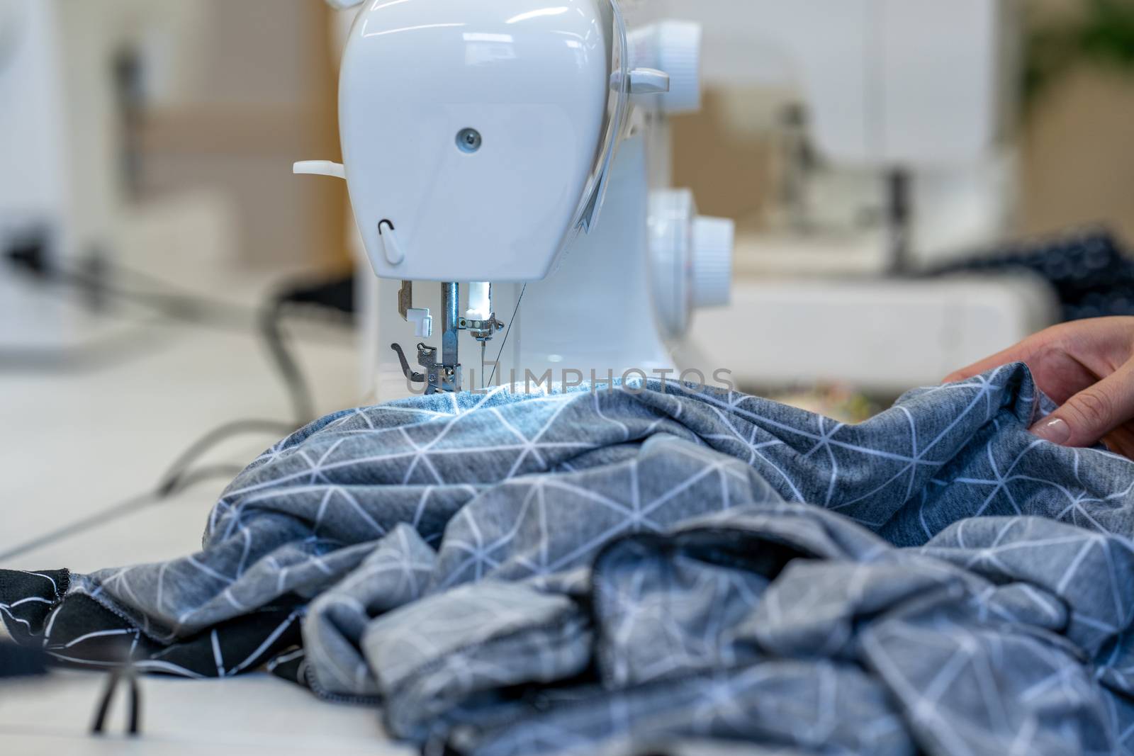 sewing cloth on a sewing machine in a tailor shop.