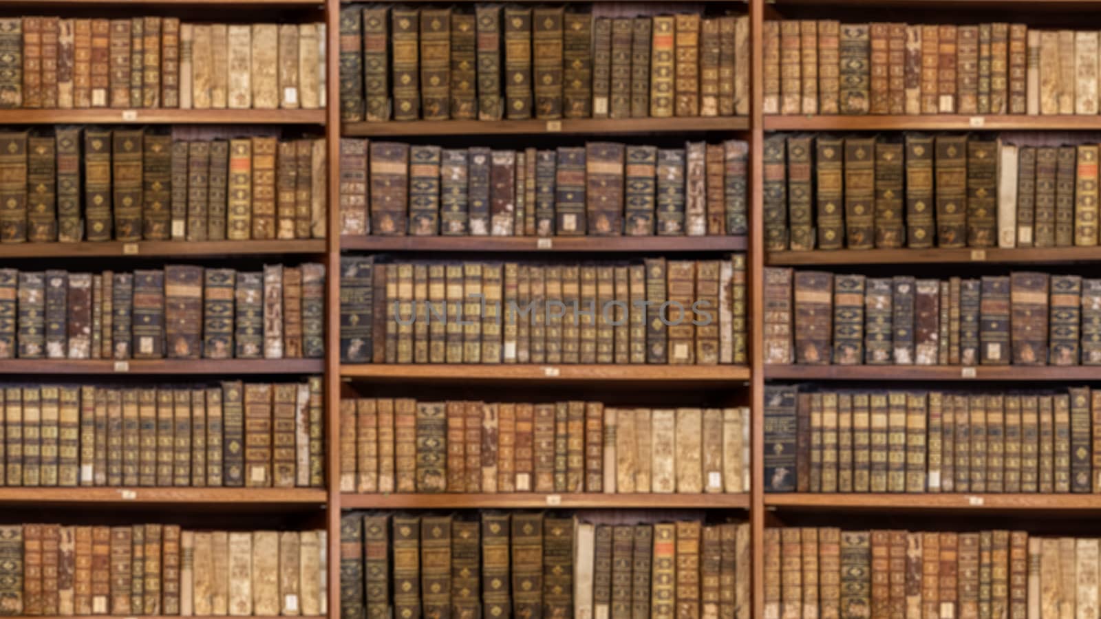 Defocused and blurred image of old antique library books on shelves for use in video conferencing background and sized to 16:9 format