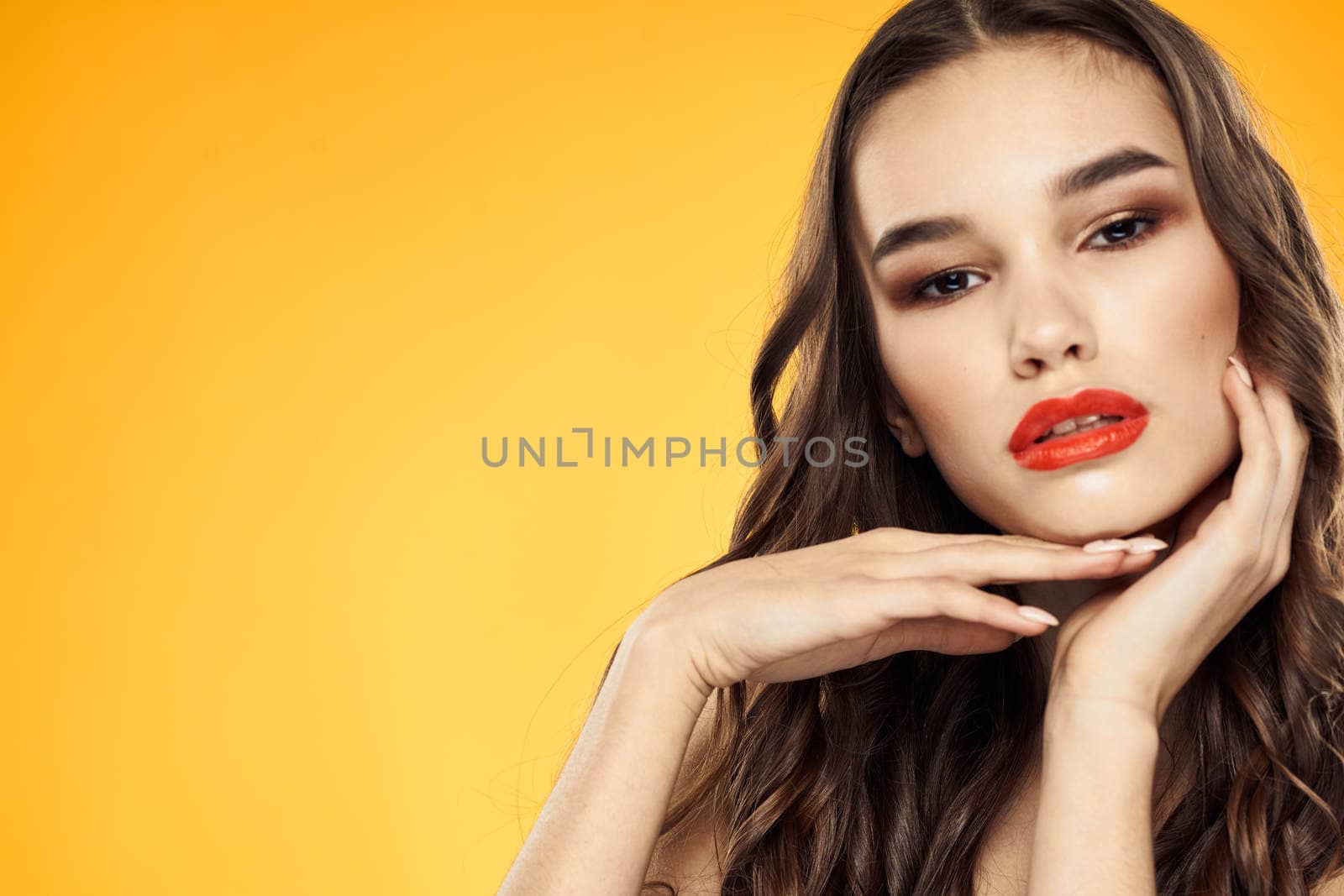 Woman with bare shoulders red cropped lips charm yellow background. High quality photo