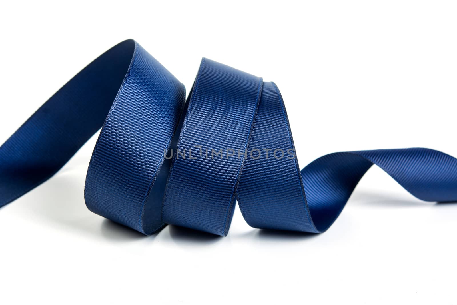 Curl blue of beautiful Satin silk holiday ribbon on a white background. copy Space for text.