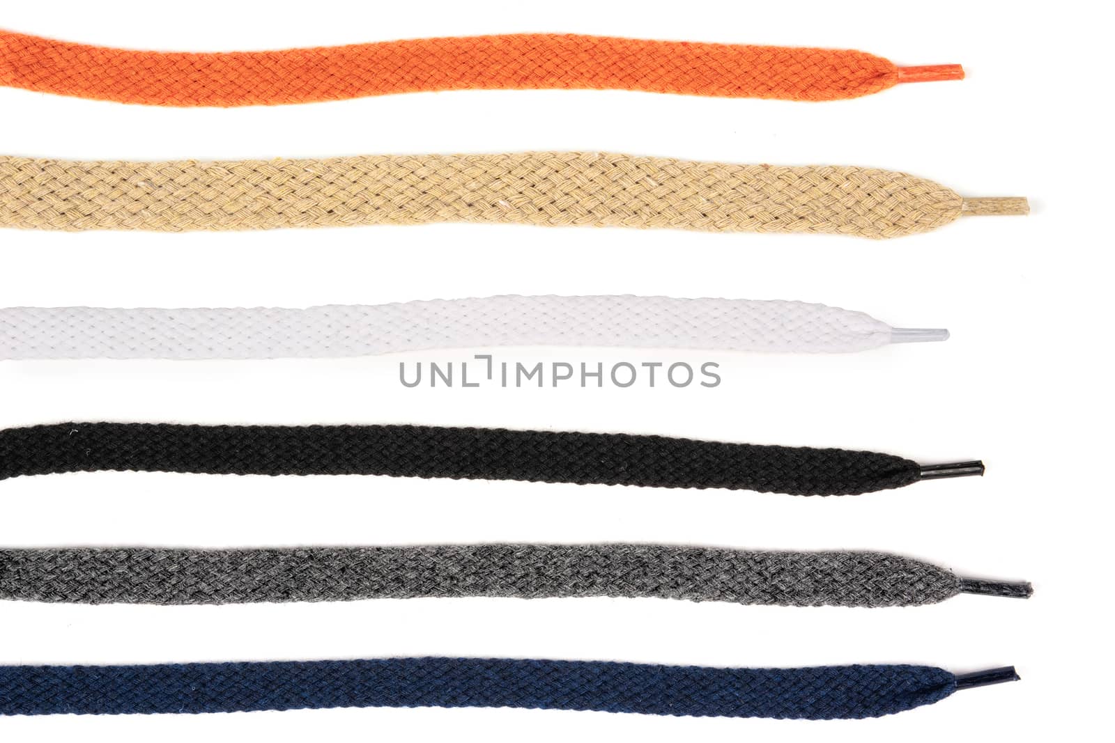Collection of colored cotton laces for shoes with tip on white background