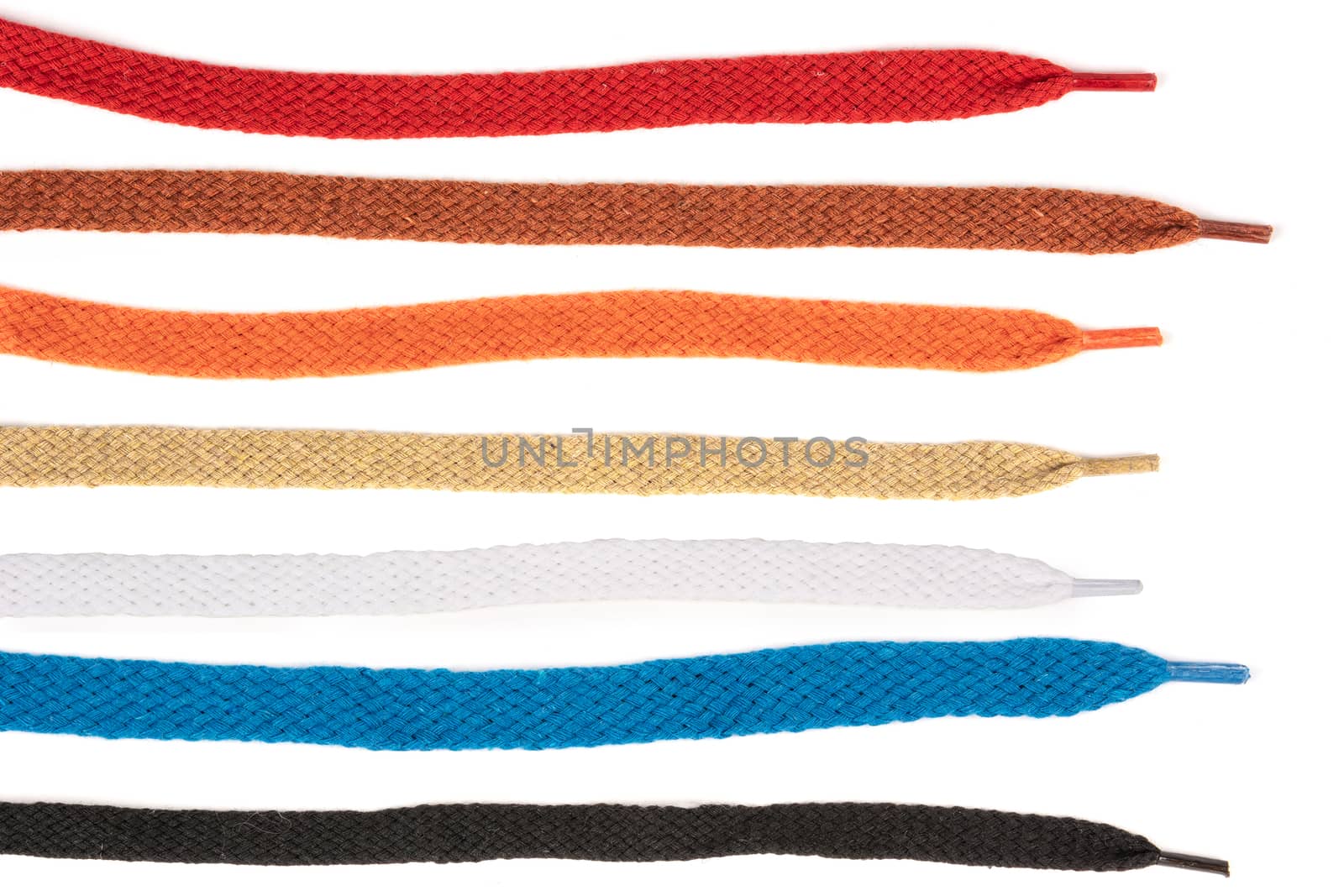 Collection of colored cotton laces for shoes with tip on white background