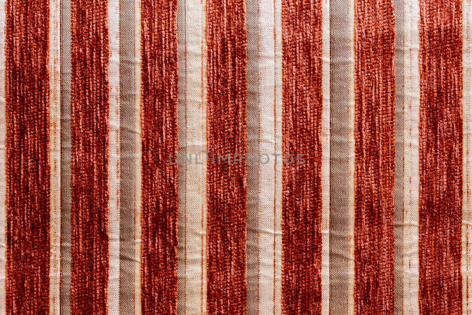 red vertical striped synthetic woven upholstery fabric close-up texture and background