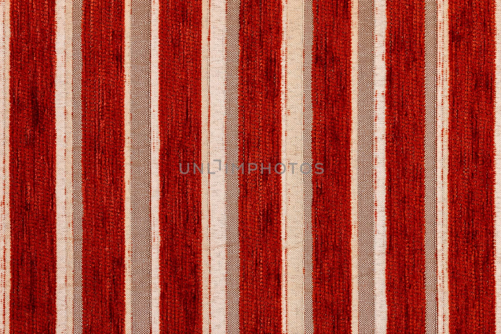 red vertical striped synthetic woven upholstery fabric close-up texture and background
