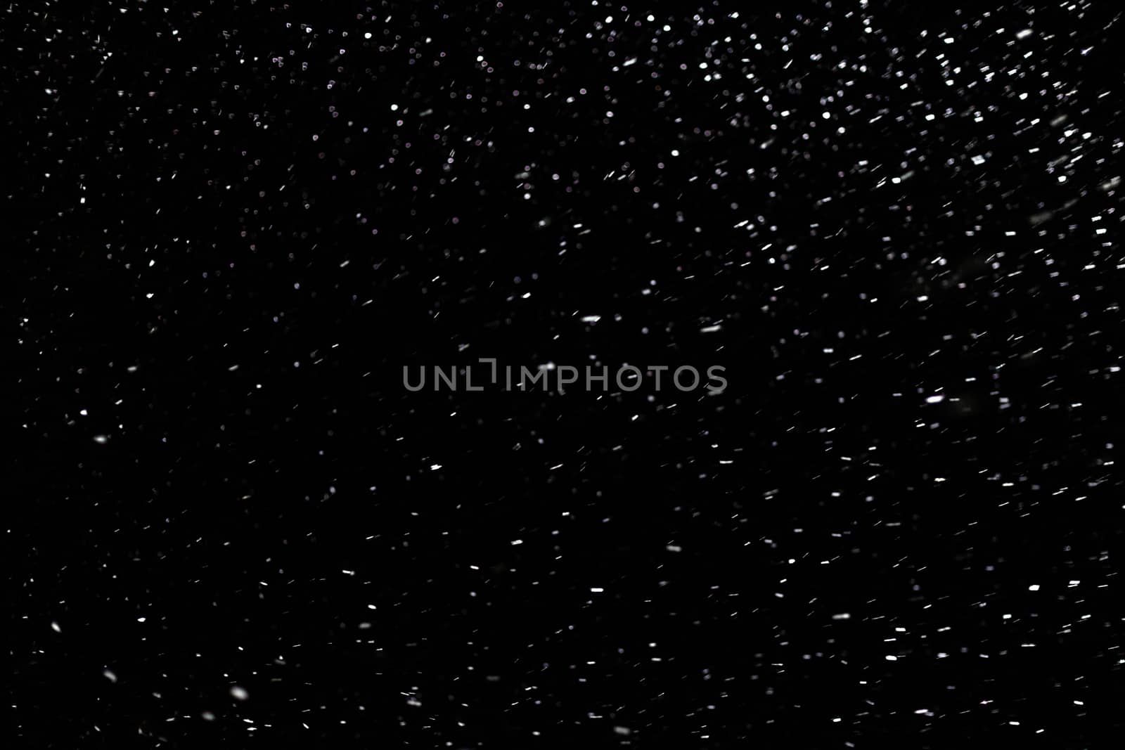 natural snow on black night background with selective focus.