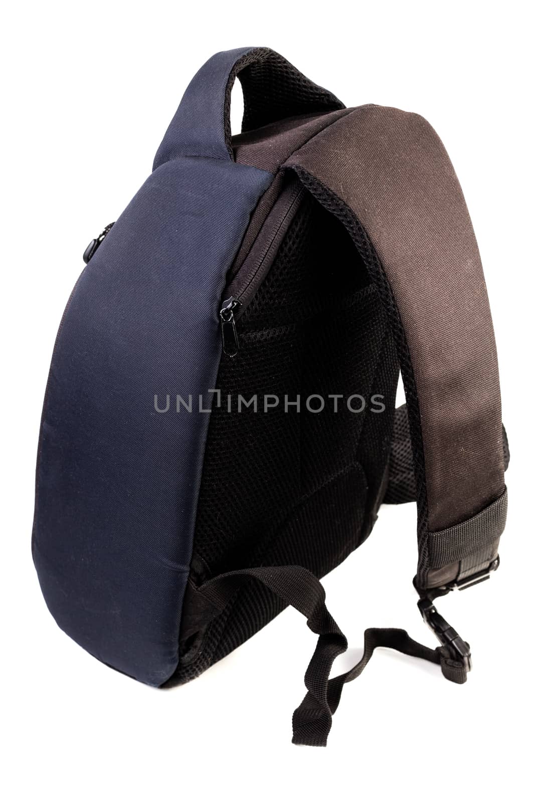 Used black and blue fabric camera bag isolated on white background with selective focus.