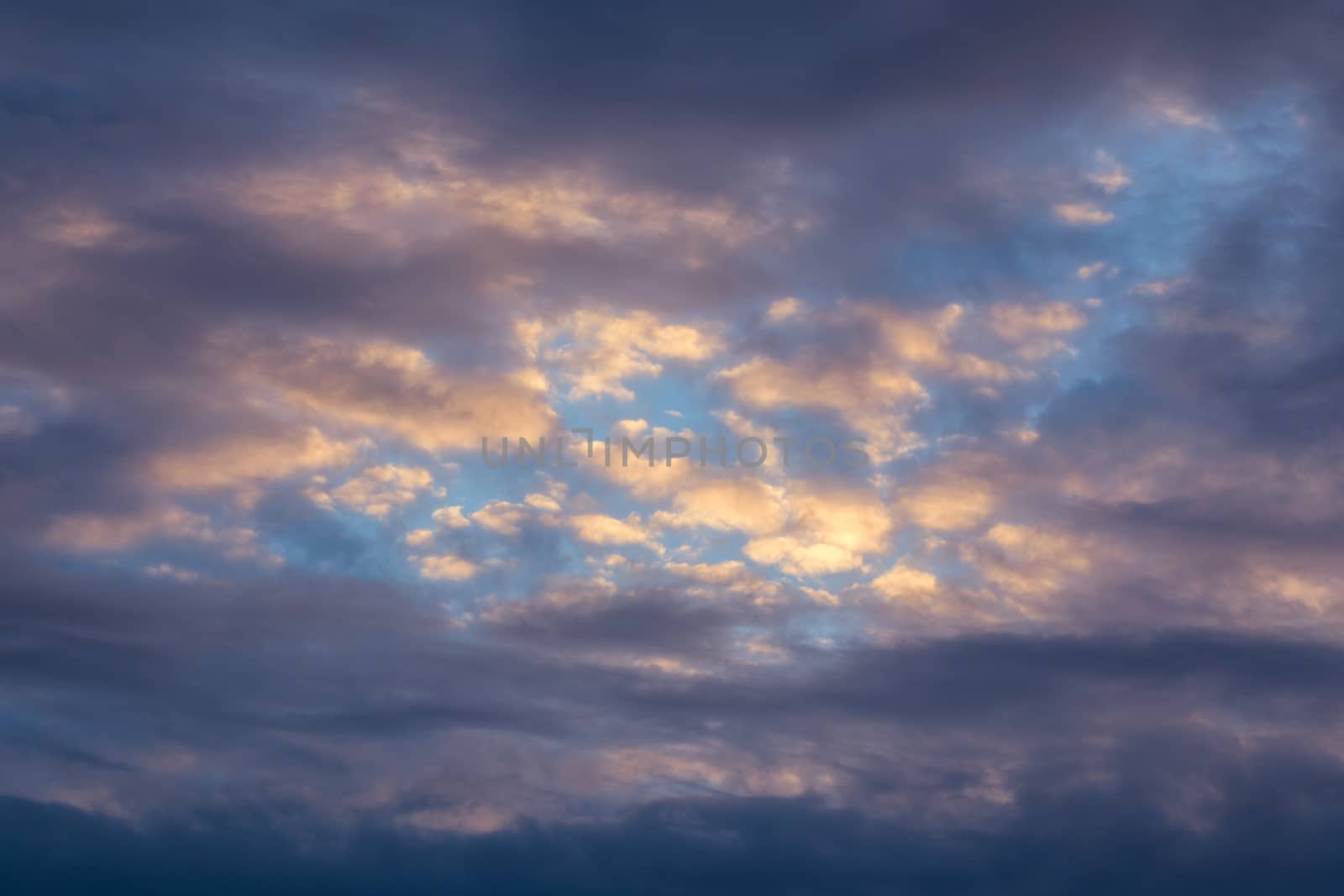 mixed clouds and blue evening sky telephoto skyscape
