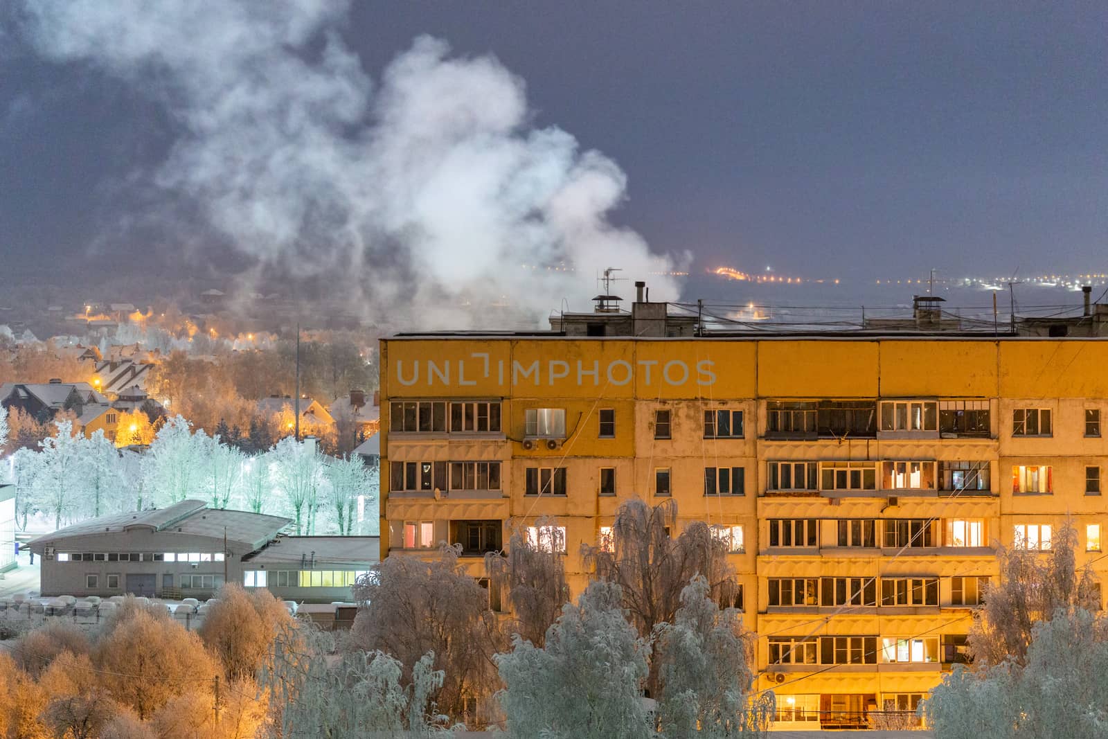 russian province high rise block house roof with steam cloud.