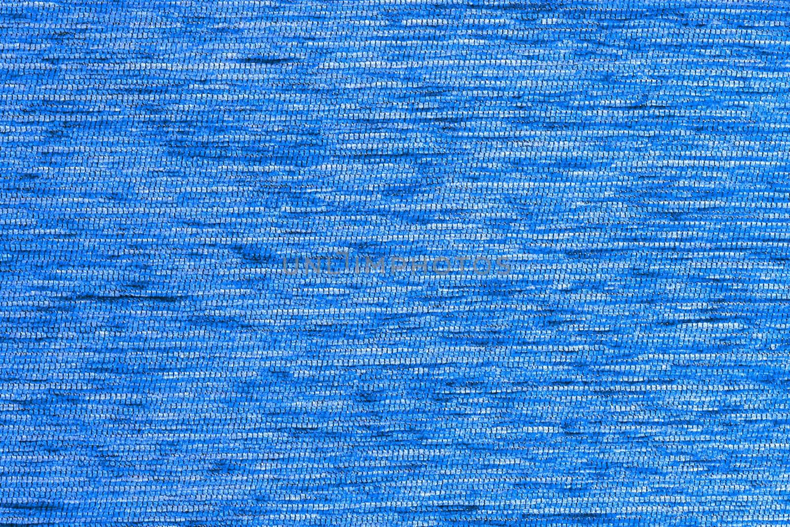 Blue flat short hard fluff dense fabric background, close up without any blurring