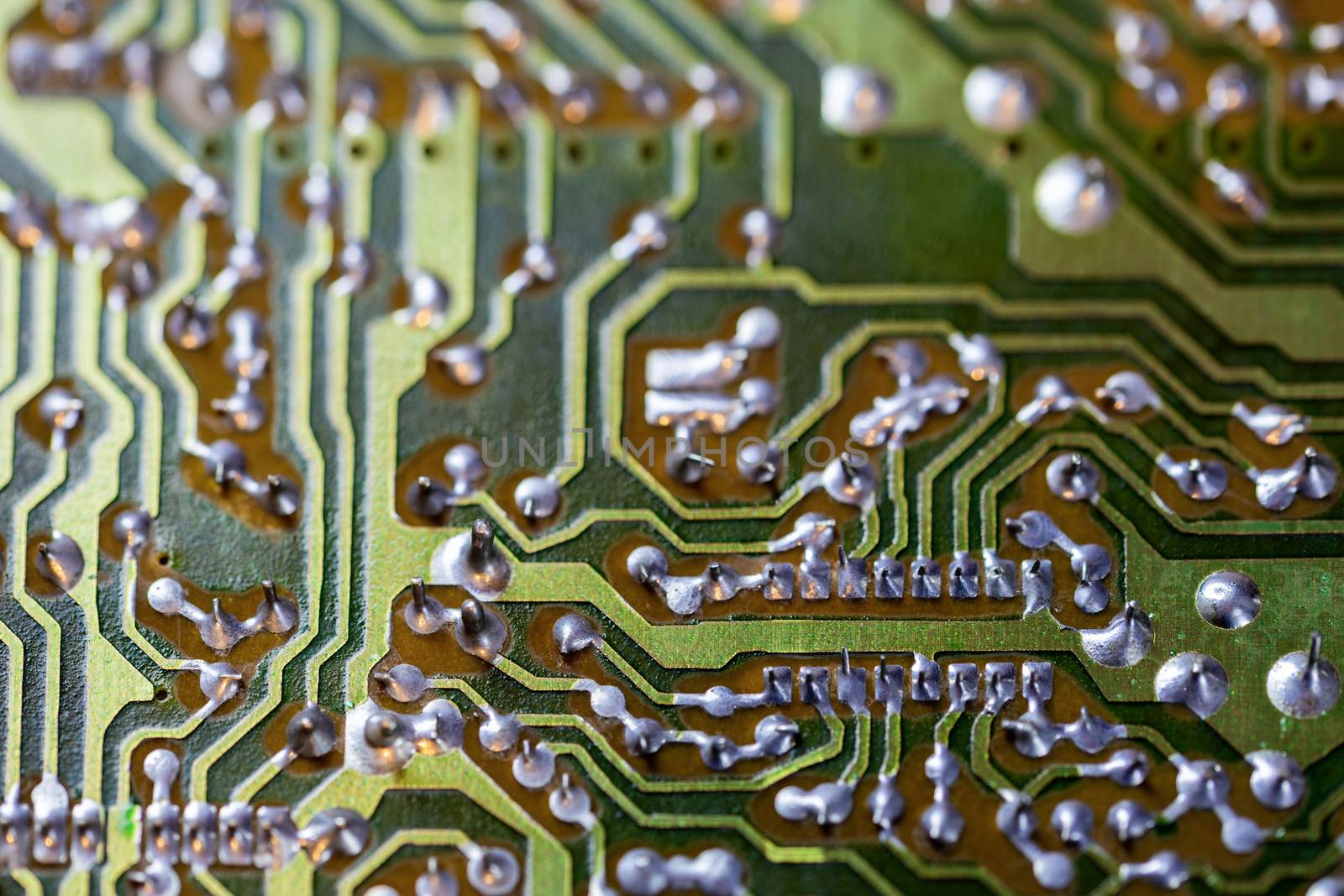 back side of two-layered green analog pcb without components selective focus background