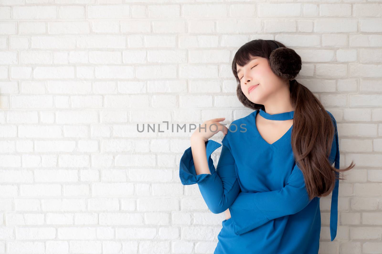 Portrait of beautiful young asian woman enjoy and happiness standing on gray cement texture grunge wall brick background, girl is a smiling and cheerful on concrete.