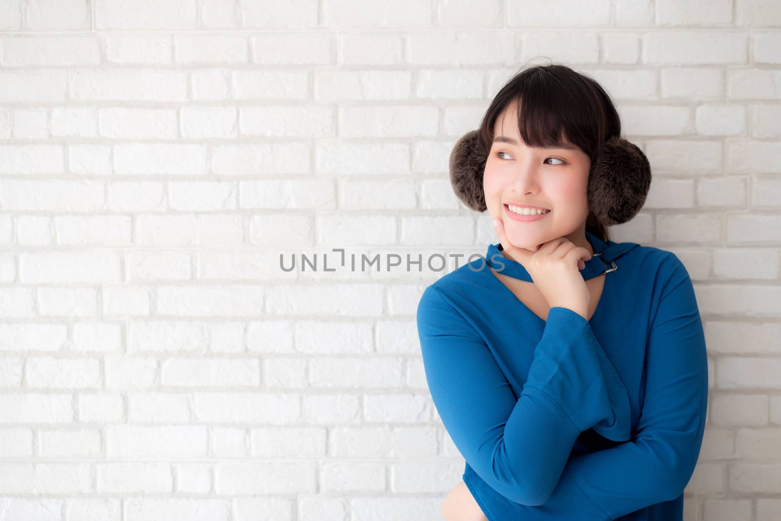 Portrait of beautiful young asian woman enjoy and happiness standing on gray cement texture grunge wall brick background, girl is a smiling and cheerful on concrete.