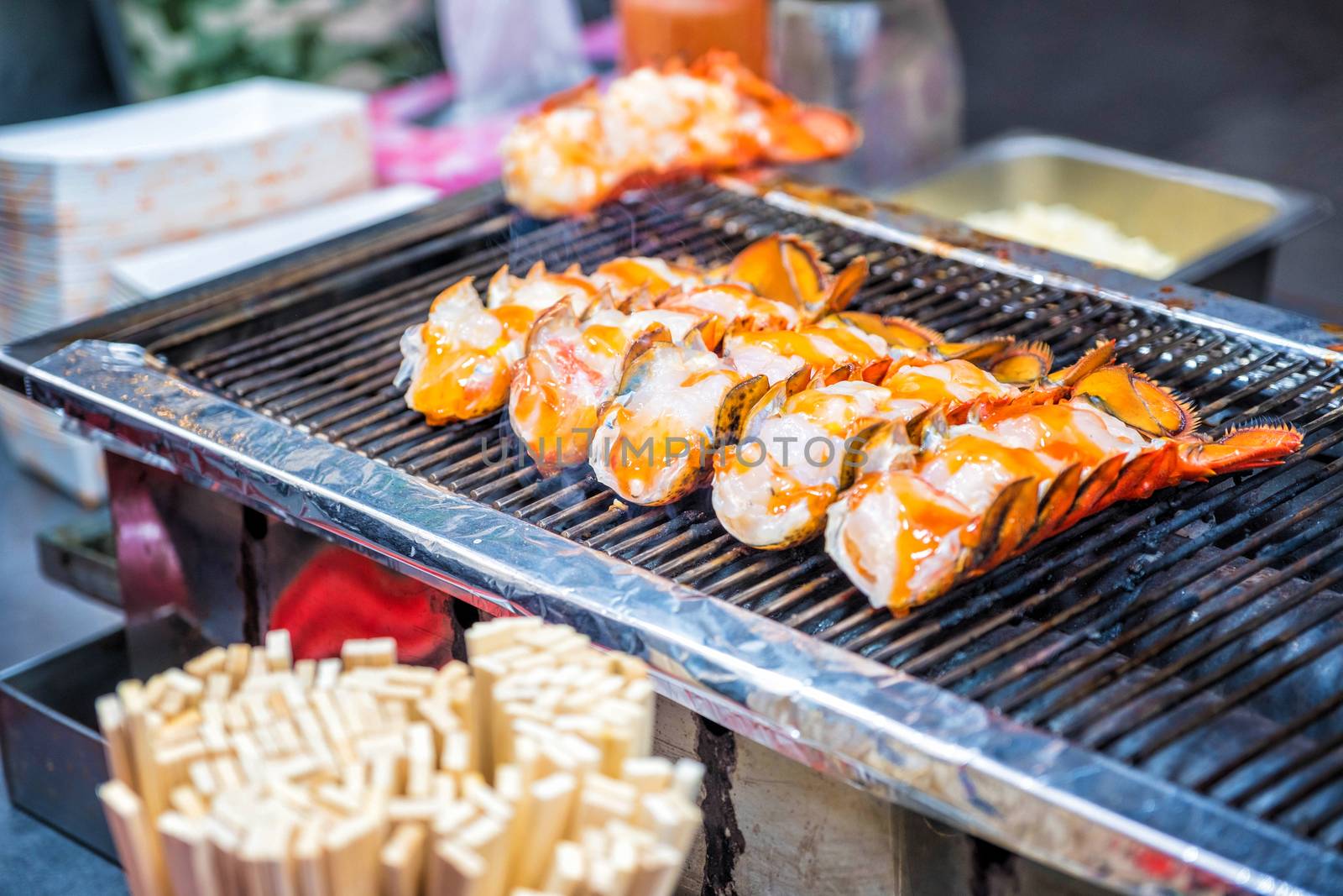 Roasted lobster with cheese at Myeong-dong street food in Seoul, South Korea