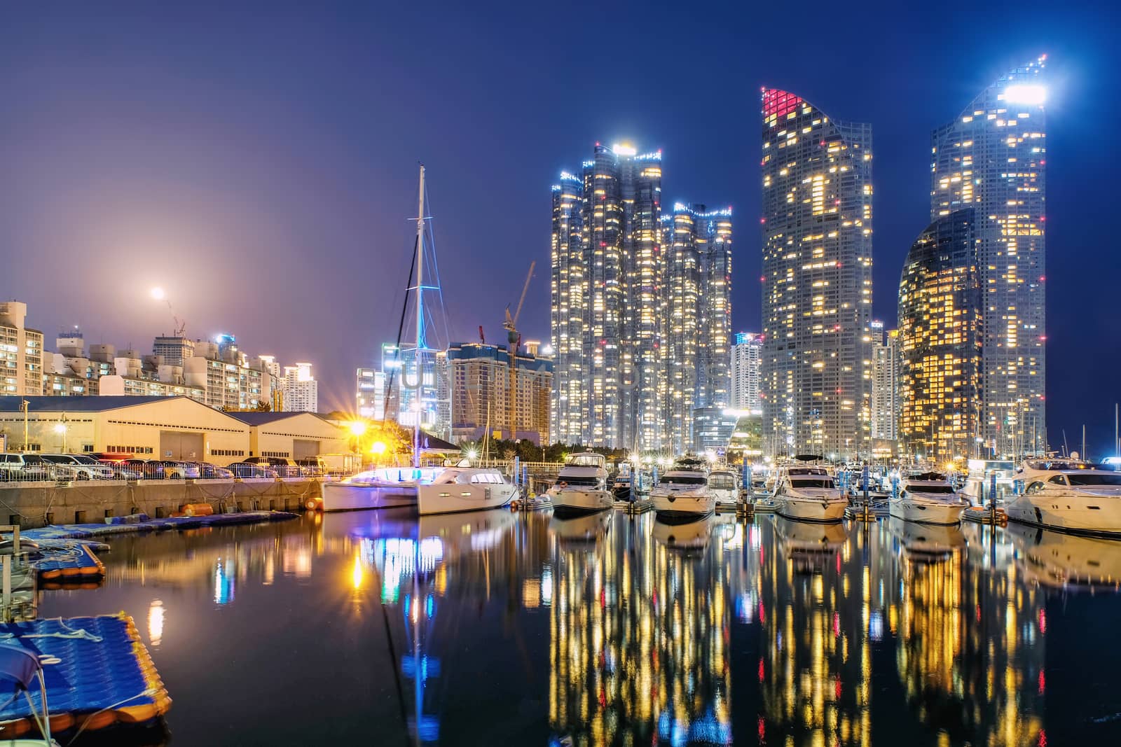 Night view of Skyscrapers Busan Marine City with reflection  by Surasak